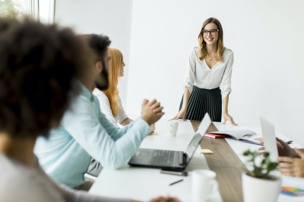 Group of businessmen and businesswomen working together in office.